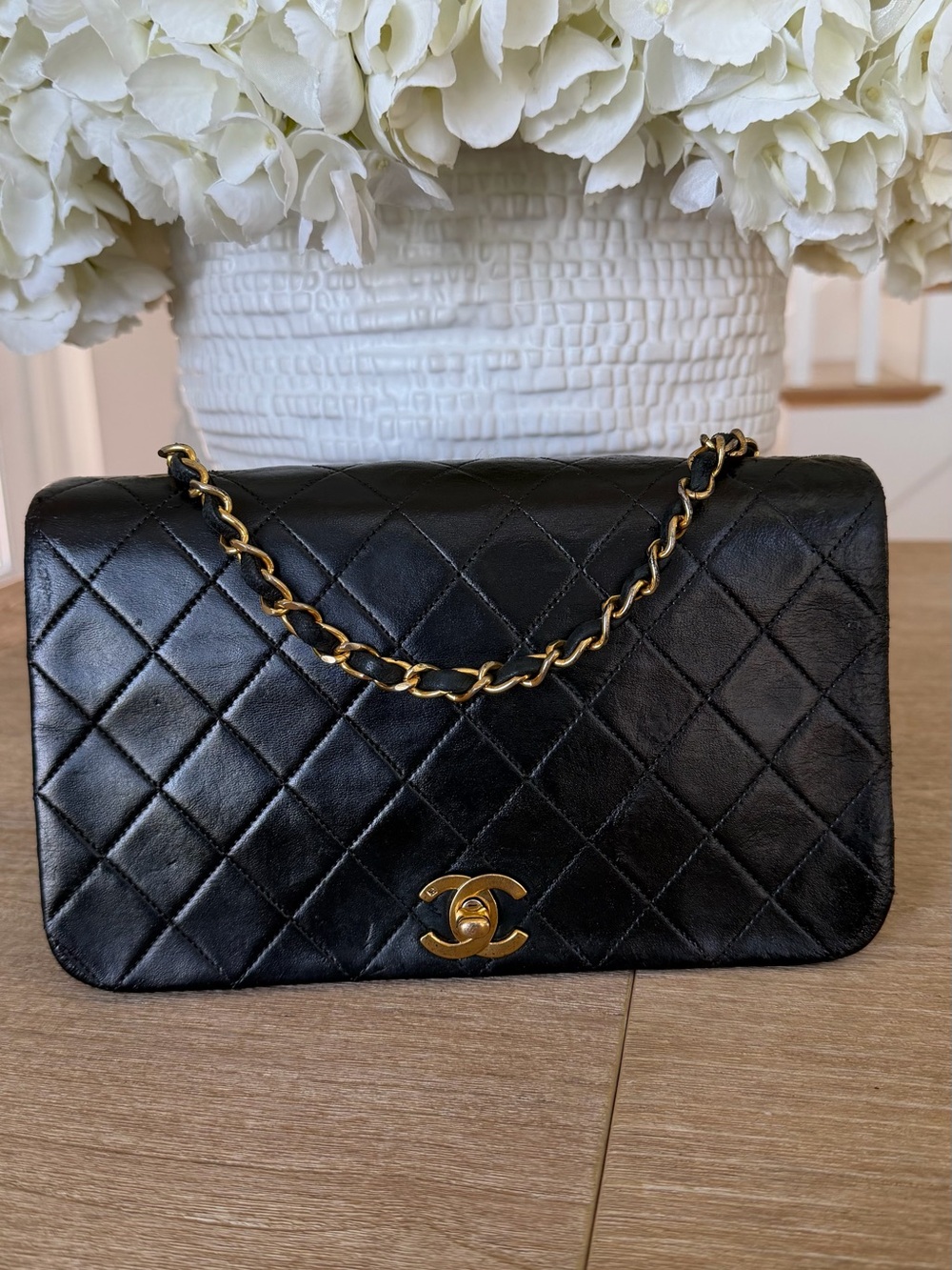 CHANEL Black Quilted Shoulder Bag with Gold Chain and CC Lock